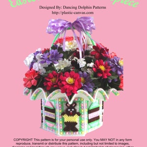 May include: A plastic canvas Easter basket centerpiece with a bunny design. The basket is decorated with pink, green, and brown stripes. The basket is filled with a bouquet of colorful flowers.