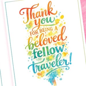 May include: Three white cards with a teal border and the words "Thank you for being a beloved fellow traveler!" in colorful watercolor lettering. The background is a pink watercolor wash.