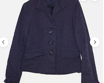 May include: A navy blue blazer with thin white pinstripes and four black buttons. The blazer has a notched collar and two front pockets.