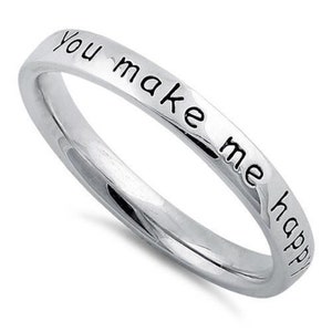 May include: A silver ring with the inscription "You make me happy" engraved on the band.