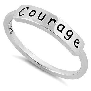 May include: Silver ring with the word "Courage" engraved on the band.
