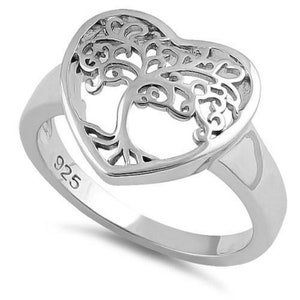 May include: Sterling silver ring featuring a heart-shaped design with a detailed tree of life cutout. The ring is marked "925" on the inside band.