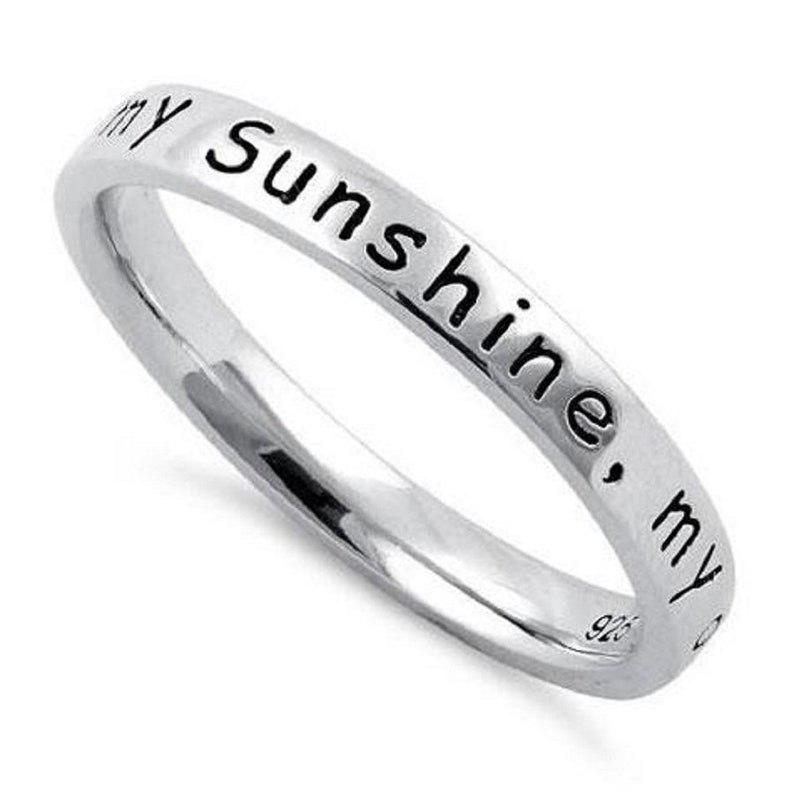 May include: A silver band ring with the inscription "my sunshine, my"