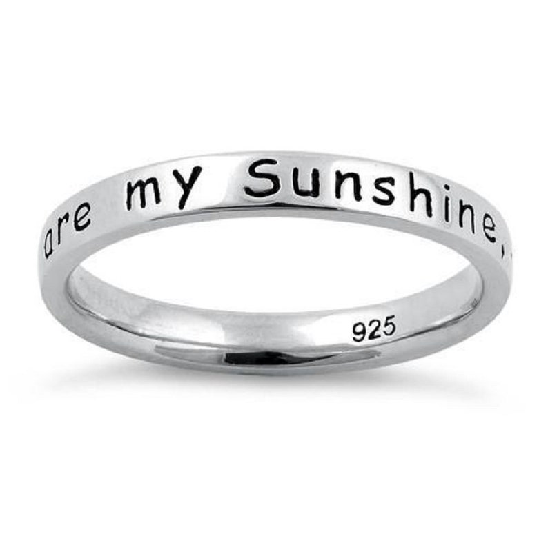 May include: A silver band ring with the inscription "You are my sunshine" on the outside of the band. The inside of the band is stamped with "925".