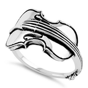 May include: A silver ring featuring a detailed violin design. The ring is made of sterling silver and has a polished finish.