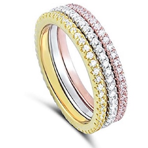 May include: Three interlocking rings with a pave setting of clear cubic zirconia stones. The rings are in yellow gold, white gold, and rose gold.