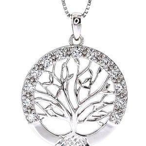 May include: Silver-toned pendant necklace featuring a tree of life design. The pendant has a circular shape with a detailed tree silhouette in the center. The outer edge is encrusted with sparkling crystals, and the necklace has a delicate chain.