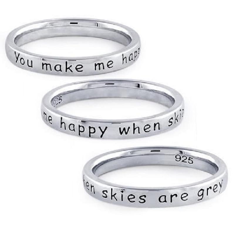 May include: Three silver rings with the inscription "You make me happy when skies are grey".