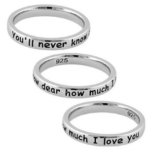 May include: Three silver rings with engraved messages. The top ring reads "You'll never know". The middle ring reads "how dear how much I". The bottom ring reads "how much I love you".