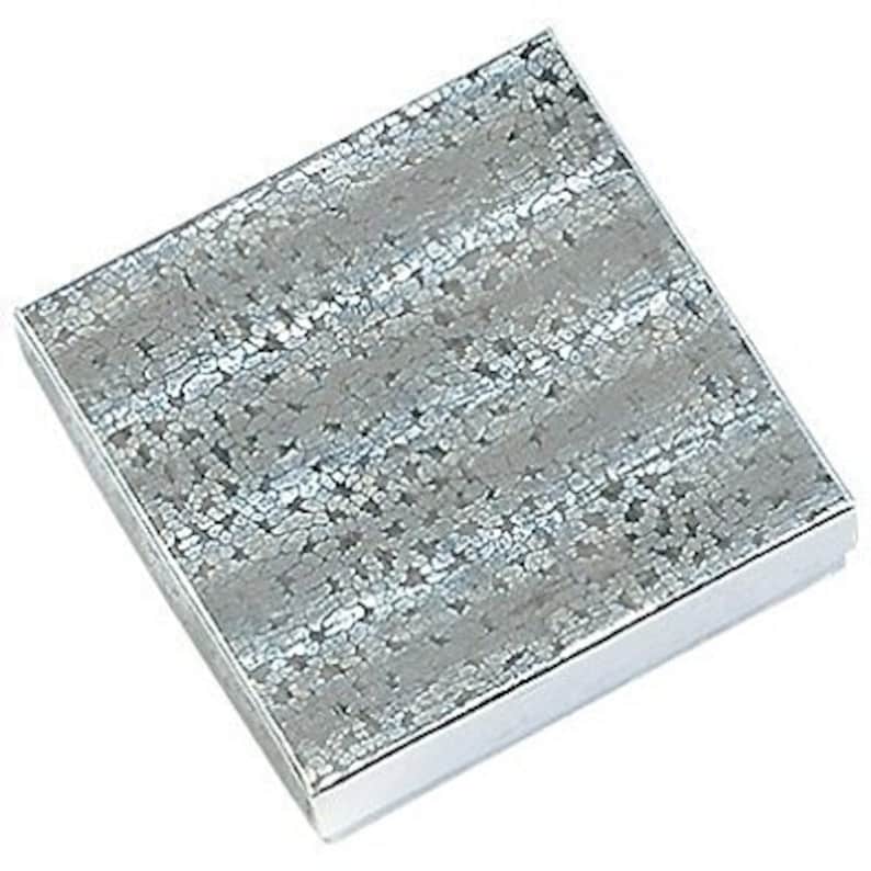 May include: A silver gift box with a textured, sparkly design.