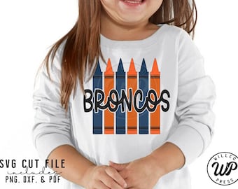 May include: A white long-sleeved shirt with the word "Broncos" written in black script. The word is surrounded by a row of six orange and blue crayons.