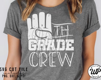 May include: A gray t-shirt with a white graphic design that says "5th Grade Crew" with a hand making the number five. The graphic has a distressed look.
