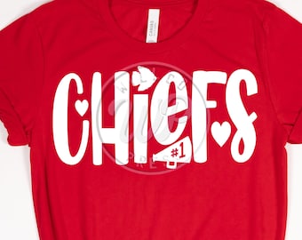 May include: Red t-shirt with white text that says "CHIEFS" with a heart on either side of the word and a white megaphone with the number "#1" in the middle.