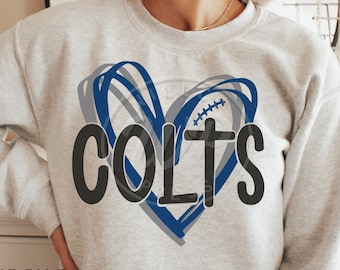 May include: A grey sweatshirt with a blue and grey heart design and the word "COLTS" in black lettering.