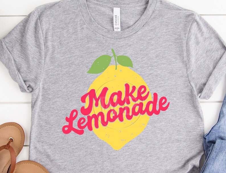 May include: Gray t-shirt with a yellow lemon graphic and the text "Make Lemonade" in pink.