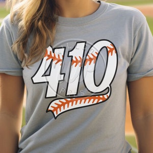 May include: A gray t-shirt with a white baseball-themed graphic that says "410".
