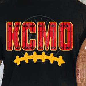 May include: Black t-shirt with a red and white football field design that spells out "KC MO".  A yellow football stitch design is below the text.