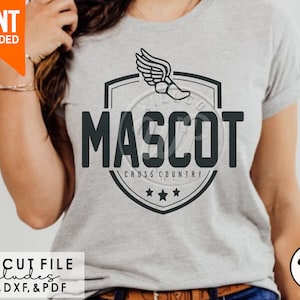 May include: A gray t-shirt with a black and white graphic of a running shoe with wings inside a shield with the text "MASCOT CROSS COUNTRY" and three stars below the text.