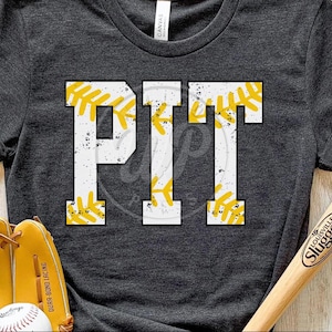 May include: A dark gray t-shirt with the word "PIT" in white letters outlined in yellow. The letters are decorated with a baseball stitch pattern.