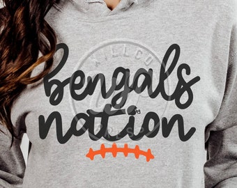 May include: A gray hoodie with the text "Bengals Nation" in black script. A football helmet graphic is above the word "Nation". An orange football stitch design is below the text.
