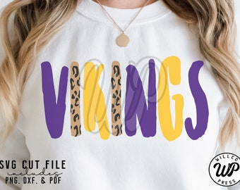 May include: Purple and yellow "VIKINGS" text with a leopard print pattern in the middle. The text is in a handwritten style.