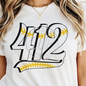 May include: White t-shirt with a black and yellow baseball-themed design featuring the number "412".