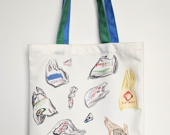 May include: A white canvas tote bag with two long handles, one green and one blue. The bag features a scattered print of various colorful plastic grocery bags with different logos and text, including Mitsuwa, 88, and Seafood City.