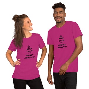 May include: Two people wearing pink t-shirts with the text "Keep Calm and Fernet About It" printed in black. The shirts feature a crown icon above the text.