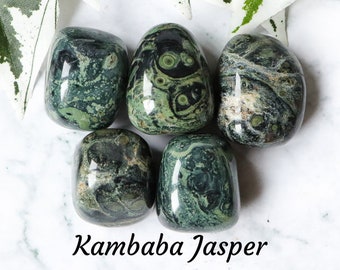 May include: Five tumbled Kambaaba Jasper stones, each with a unique green and black marbled pattern. The stones are smooth and polished, with a glossy finish.