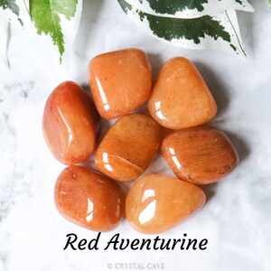 May include: Seven smooth, polished red aventurine tumbled stones. The stones are a deep reddish-orange colour with a slight shimmer.