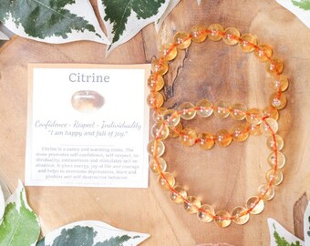 May include: A citrine crystal bracelet with a card that reads "Citrine, Confidence, Respect, Individuality, 'I am happy and full of joy.'" Citrine is a sunny and warming stone. The stone promotes self-confidence, self-respect, individuality, extraversion and stimulates self-realization. It gives energy, joy of life and courage and helps to overcome depressions, fears and phobias and self-destructive behaviour. Crystal Cave.