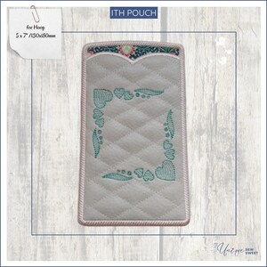 May include: A rectangular, quilted pouch with a decorative teal border and teal heart and leaf embroidery. The top edge features a floral design. The text "ITH POUCH" is at the top. The text "for Hoop 5 x 7" / 130x180mm" is on a sticky note.