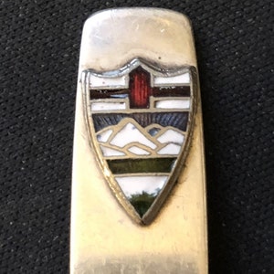 Crest with Mountains (top) on Silver Plated Demitasse Spoon - pre-owned