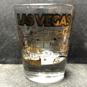 Las Vegas, Nevada with Marina Hotel, Hecienda, Aladdin, Savara, etc in 22K Gold on 1oz Glass Shot Glass - NEW