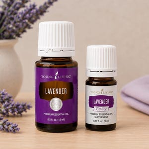 May include: Two amber glass bottles of Young Living Lavender essential oil with white caps. The larger bottle is labeled 0.5 fl. oz. (15 ml) and the smaller bottle is labeled 0.17 fl. oz. (5 ml) with the word Vitality printed on the label.
