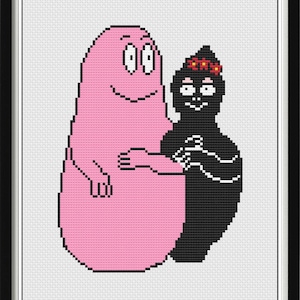 May include: A framed cross-stitch featuring two cartoon characters. One is a large pink figure with a smiling face and arms. The other is a smaller black figure with a floral crown. The figures are embracing. The background is white.