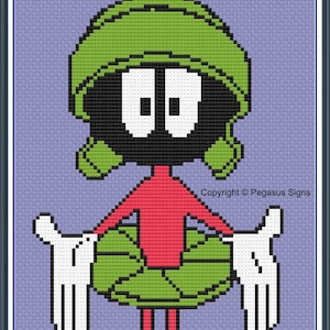 May include: Cross-stitch pattern featuring Marvin the Martian from Looney Tunes. The character is depicted in his signature green helmet, red top, and white gloves and shoes. The background is a light purple color, with the text "Crochet & Knitting" at the top.