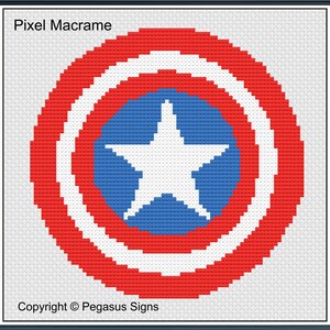 May include: A cross-stitch pattern depicting a shield design in red, white, and blue. The shield has concentric circles with a white star in the centre. The text "Pixel Macrame" and "Copyright © Pegasus Signs" are visible.