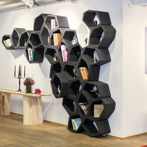 Enhance your decor with this set of sustainable modular black hexagon-shaped wall shelves and bookcases, offering versatility as wall shelves, hanging shelves, or freestanding units. Elevate your space with this eco-friendly choice.