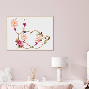May include: A gold stethoscope with a heart shape formed by the tubing, decorated with pink, white, and purple watercolor flowers.