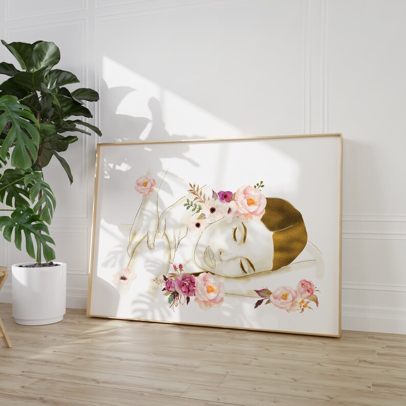 May include: A digital illustration of a person with a gold-toned skin tone, lying on their side with their eyes closed. The person is wearing a crown of pink and white flowers. The background is white.