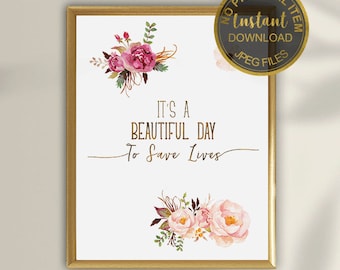 May include: Printable digital download of a quote that reads "It's a beautiful day to save lives" with pink floral illustrations. The text is in gold lettering. The image has a white background and a gold frame.