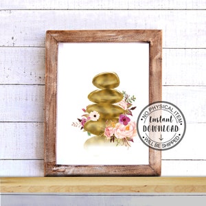 May include: A digital print of a gold zen stack of stones with pink and purple flowers. The print is framed in a brown wood frame.