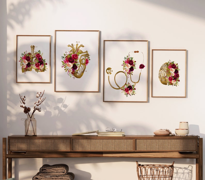 May include: Set of four framed prints featuring anatomical illustrations of the heart, lungs, brain, and stethoscope, all adorned with burgundy and white floral arrangements.