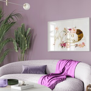 May include: A white framed print of a woman with a flower crown sleeping with a white bird on a white background.