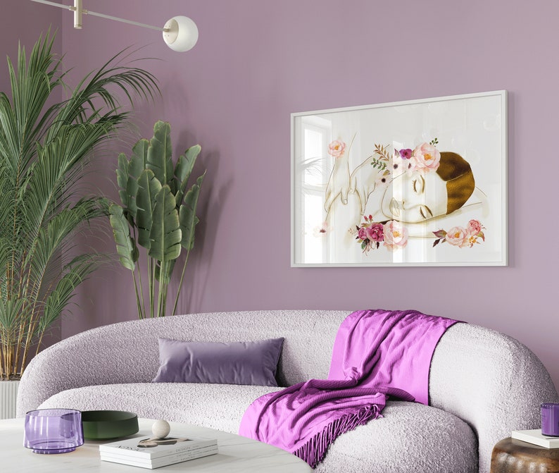 May include: A white framed print of a woman with a flower crown sleeping with a white bird on a white background.