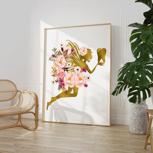 May include: A gold silhouette of a fairy holding a tooth, surrounded by pink and purple watercolor flowers. The fairy is flying with wings and a floral crown.
