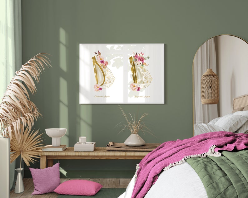 May include: A white framed print with two gold harp silhouettes decorated with pink and white flowers. The print is hanging on a sage green wall above a wooden bench with pink pillows.