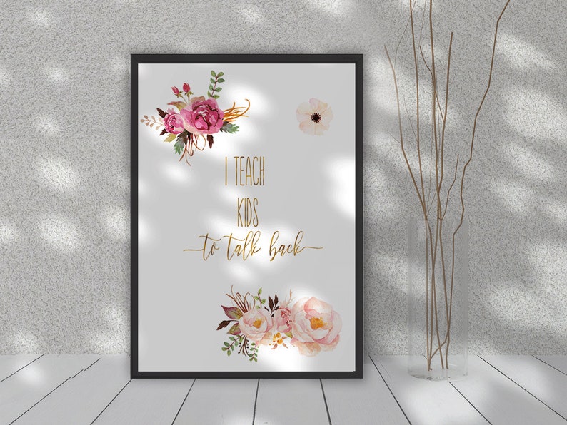 May include: A framed print with a white background and pink and gold floral illustrations. The text "I teach kids to talk back" is written in gold lettering.