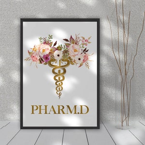 May include: A white printable poster with a gold caduceus symbol surrounded by pink and white watercolor flowers. The text "PHARM.D." is written in gold below the symbol.